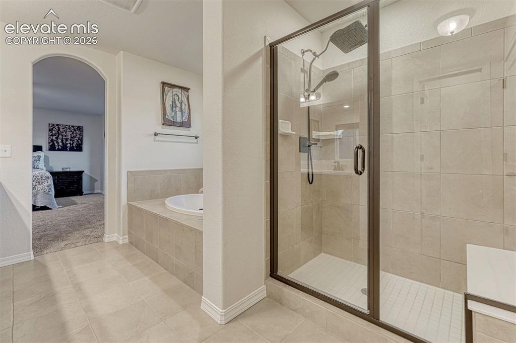 Image 43 of 49: Spa shower with glass door and bench