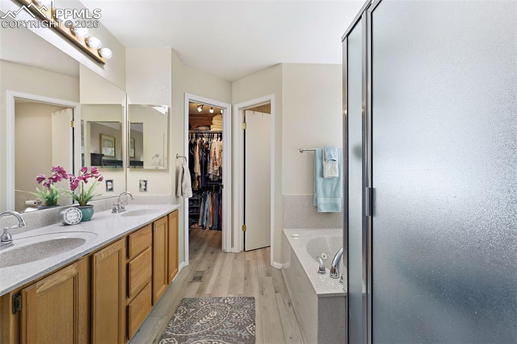 Image 11 of 29: Primary ensuite 5-piece bath and walk-in closet