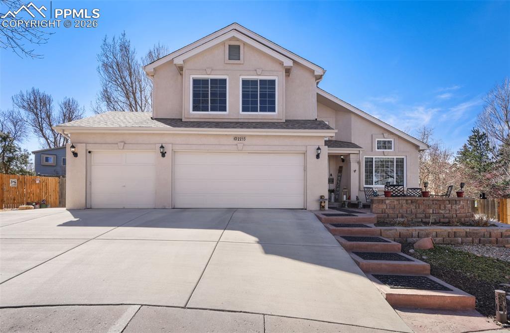 Image 2 of 29: Front of house featuring 3 car garage and landscaping