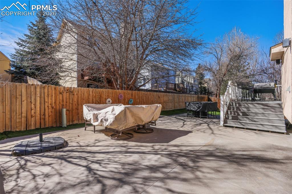 Image 25 of 29: Back of house featuring Astroturf, deck and private backyard