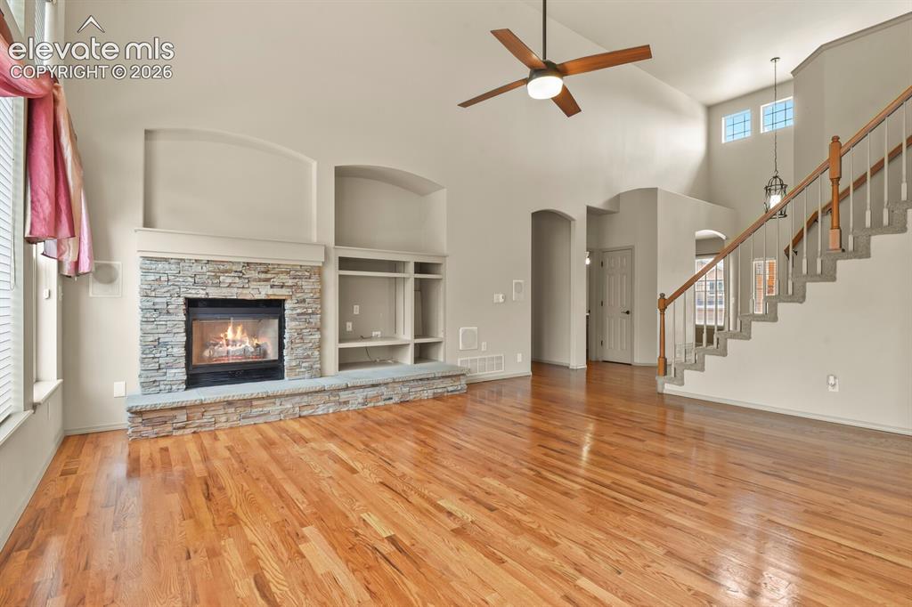 Image 13 of 50: Living room with Hardwood Flooring and Towering Ceilings
