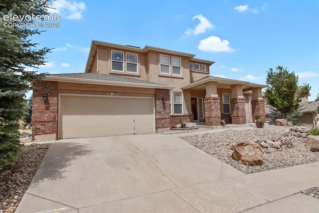 Image 2 of 50: 2 Stor residence featuring a three-car tandem garage, stone and stucco exte