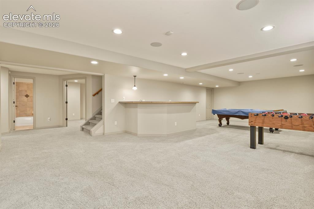 Image 29 of 50: Game room Area with Ful Wet Bar