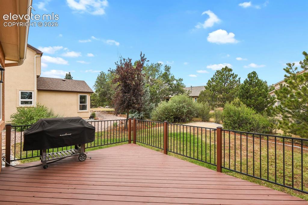 Image 41 of 50: Spacious outdoor deck featuring Trex Style decking, Gas Grill and black met