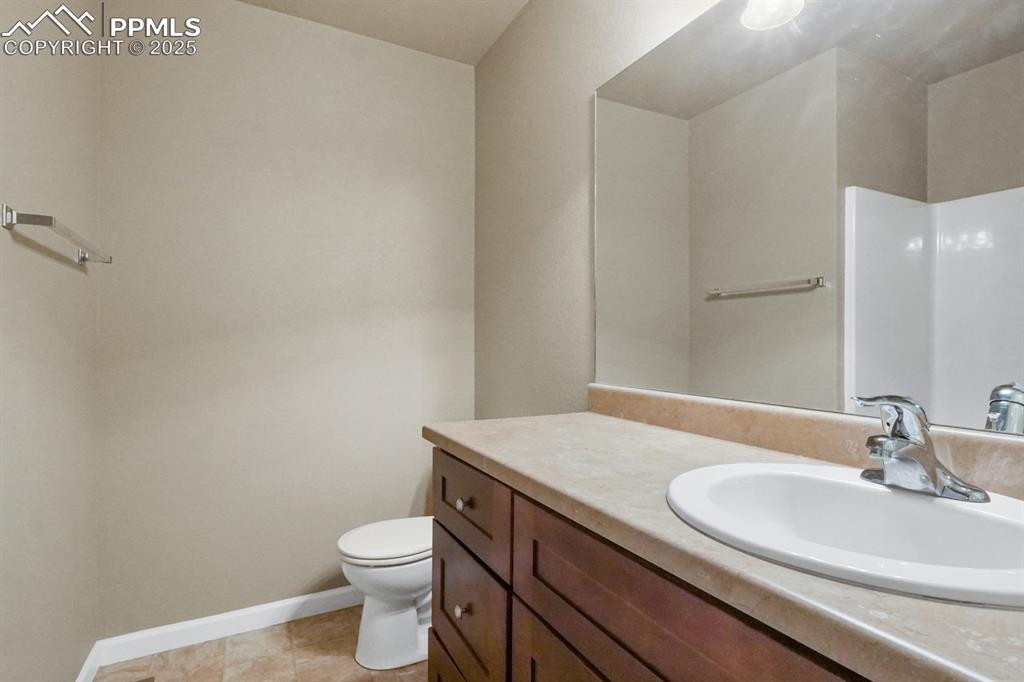 Image 10 of 18: Bathroom with vanity and tile patterned flooring