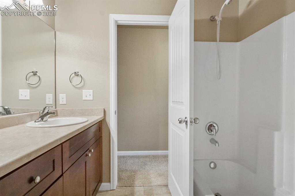 Image 11 of 18: Full bath with vanity and washtub / shower combination