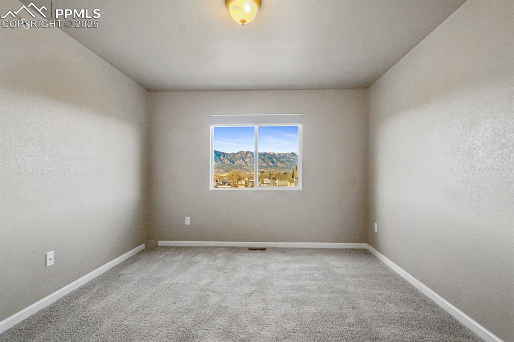 Image 12 of 18: Unfurnished room with carpet and baseboards