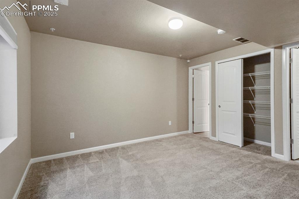 Image 7 of 18: Unfurnished bedroom with carpet flooring and a closet