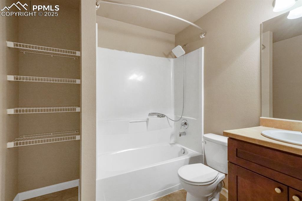 Image 8 of 18: Full bathroom with shower / bath combination, vanity, and tile patterned fl