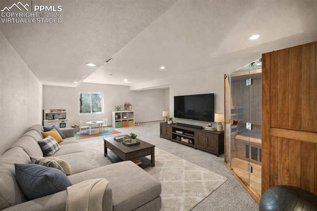 Image 12 of 46: Shown virtually staged basement family room