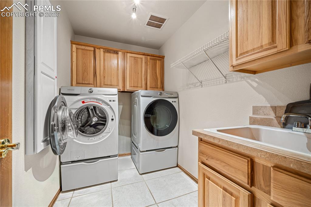 Image 32 of 46: Laundry area with ample room