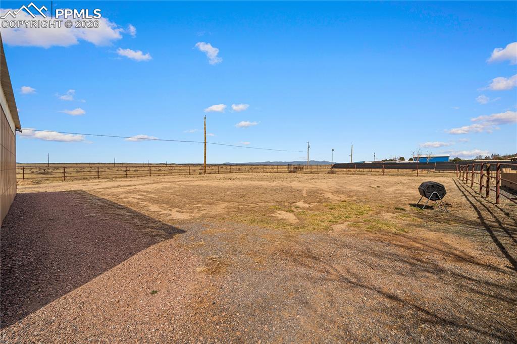 Image 42 of 46: Large fenced in back yard, property backs up to field