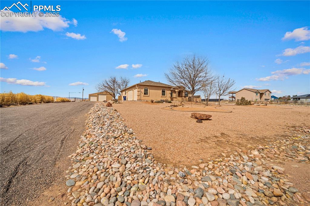 Image 43 of 46: Home sits back from road with large front yard