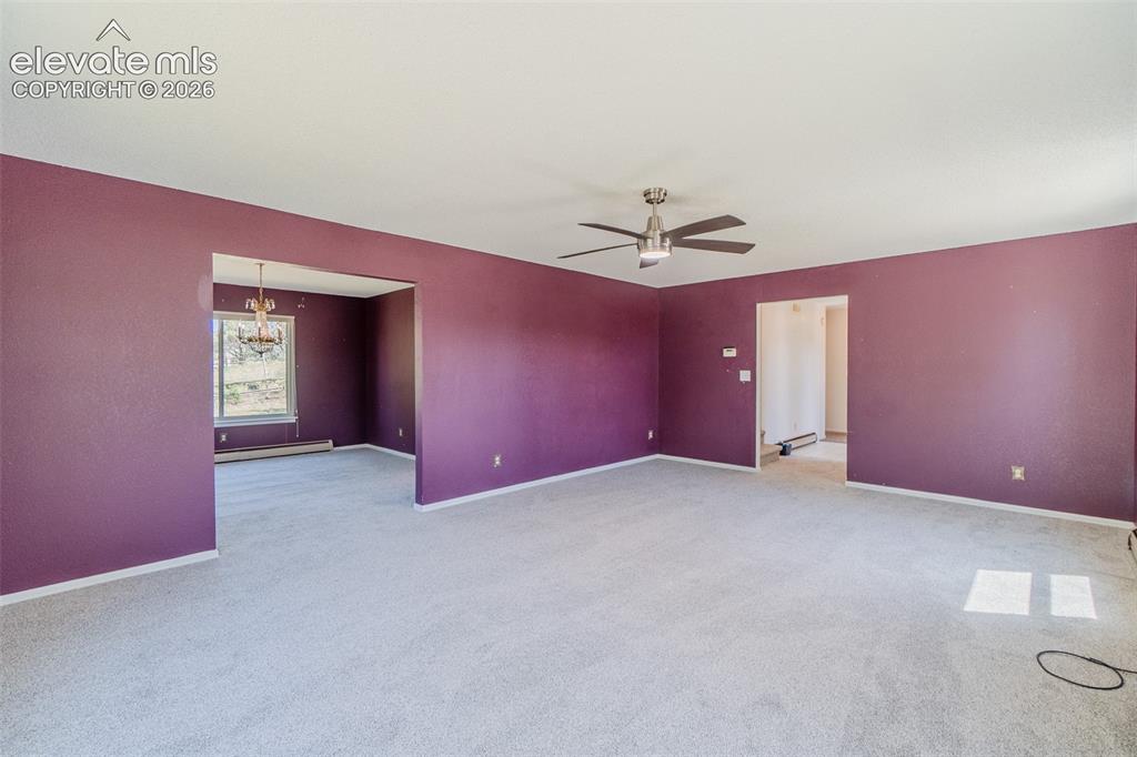 Image 19 of 47: Carpeted flooring throughout, recessed archways, and a ceiling fan with int