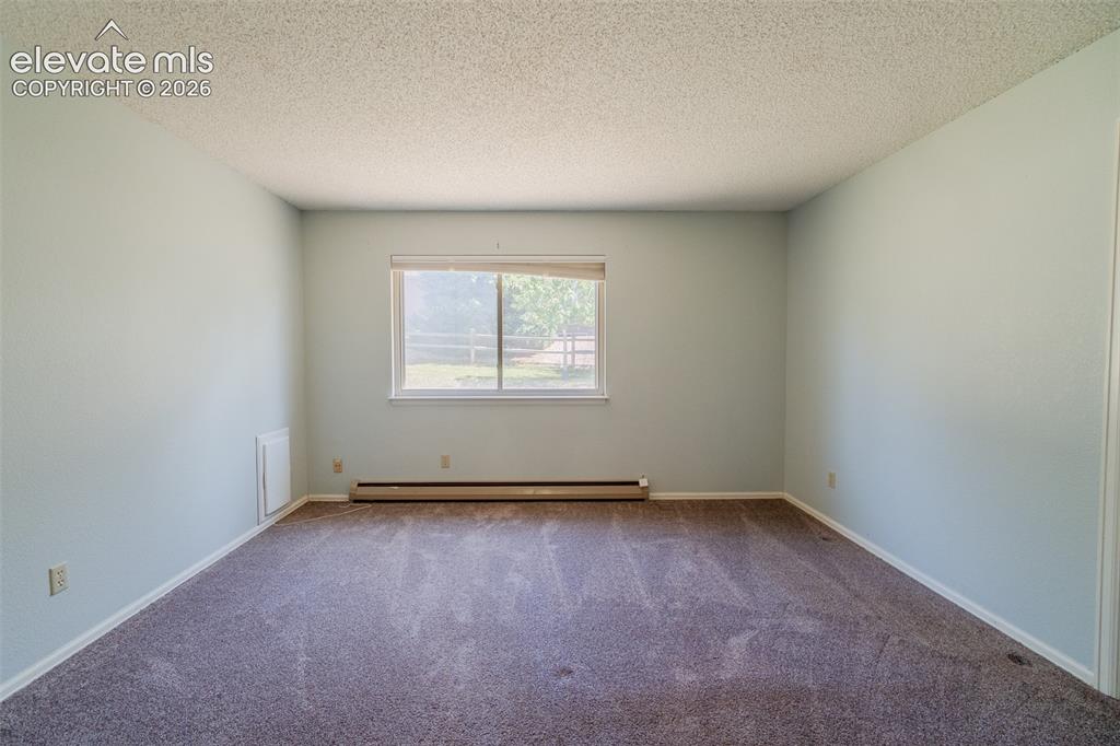 Image 24 of 47: Main level Bedroom with doggy door