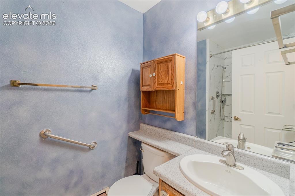 Image 25 of 47: Main level bathroom with Vanity, safety bars, stand up shower