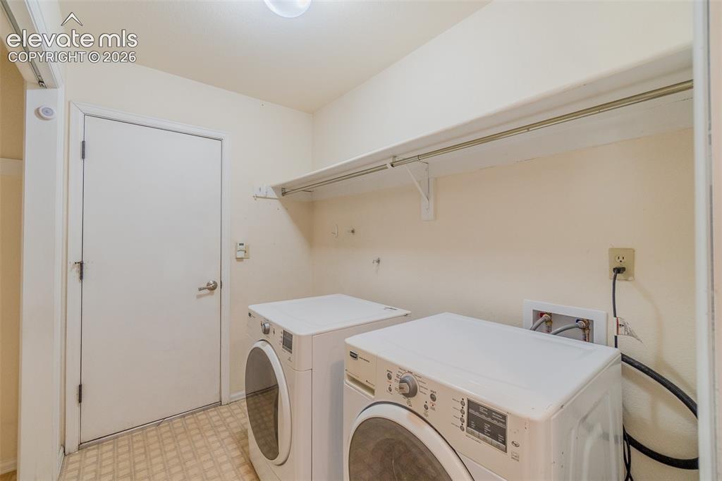 Image 26 of 47: Main level laundry room with access to the garage. 
