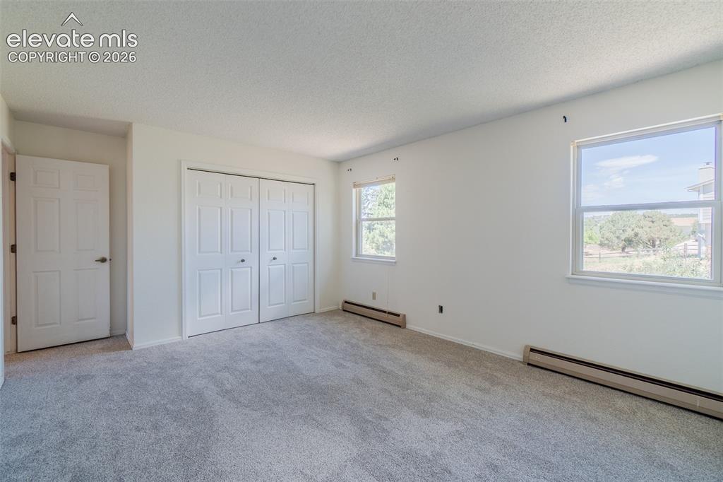 Image 31 of 47: One of Four Spacious upstairs bedroom featuring light gray new carpet, neut