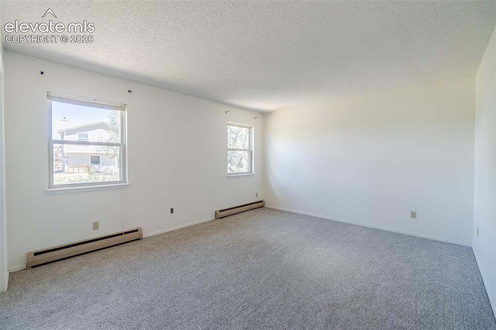 Image 32 of 47: One of Four upstairs Spacious bedroom with brand new light-colored carpetin