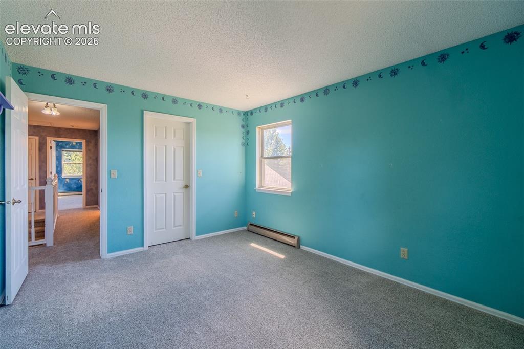 Image 35 of 47: Three of Four bedrooms upstairs, new Carpet featuring a white interior door