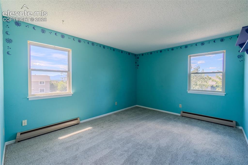 Image 36 of 47: Three of Four upstairs bedroom with new carpet with two large windows
