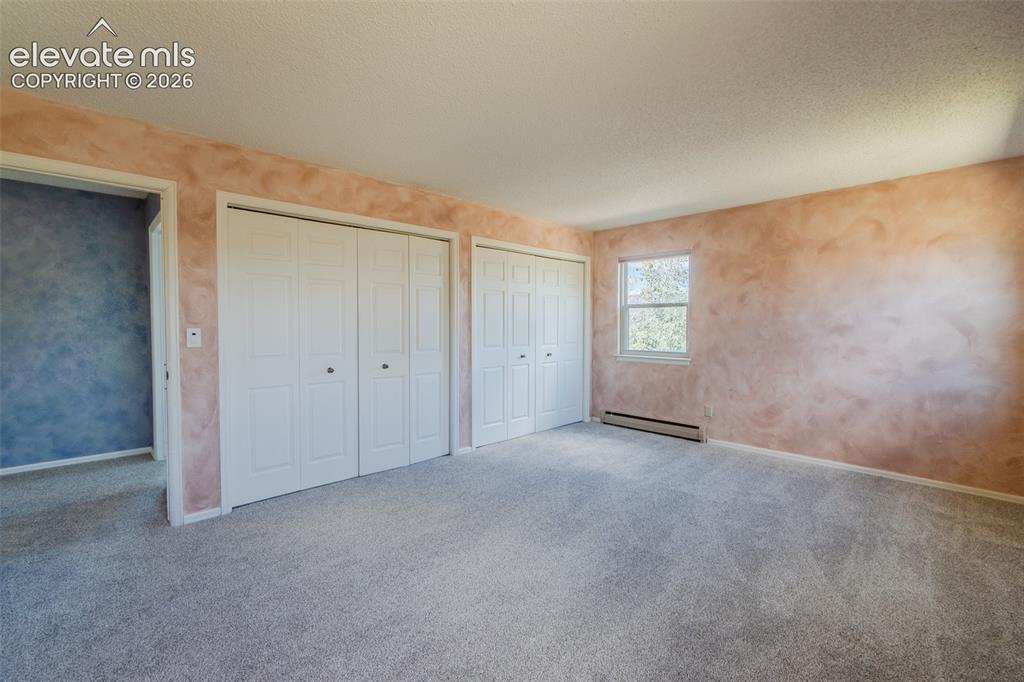Image 37 of 47: Expansive Fourth bedroom upstairs with new carpet Soft-toned wall finish, m