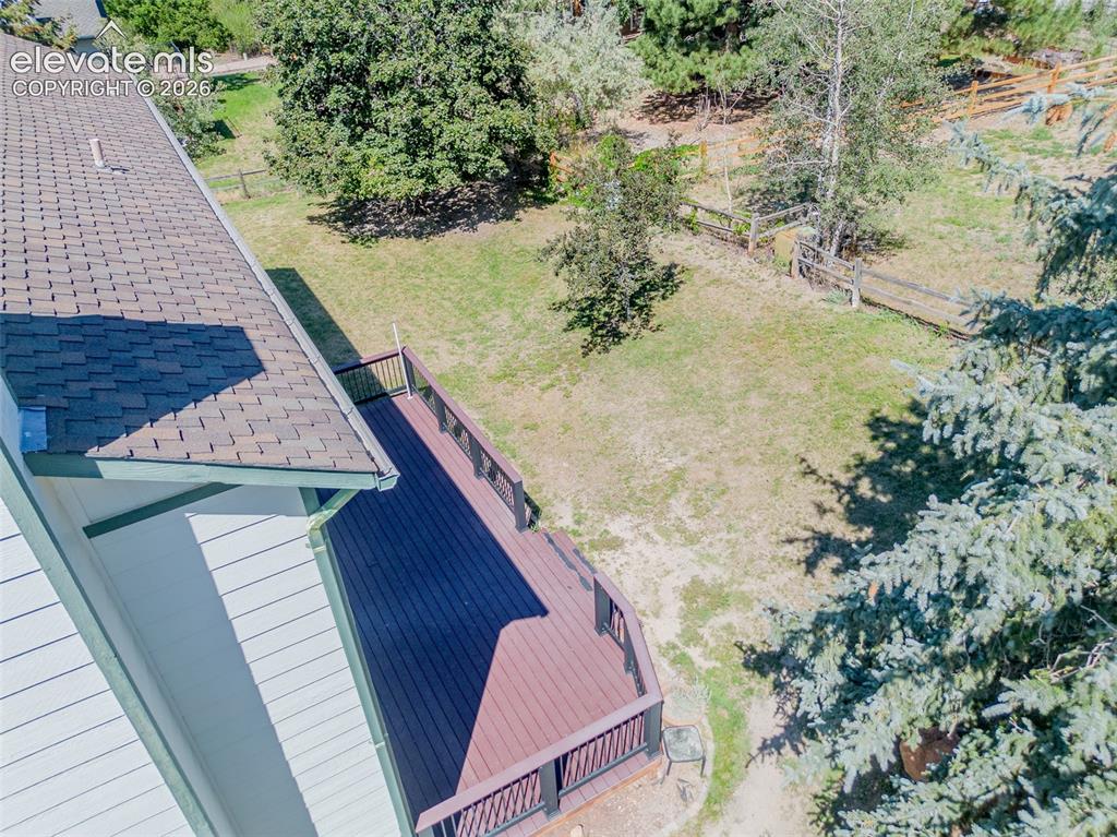 Image 7 of 47: Expansive outdoor deck with dark railing, composite decking, and a shingle