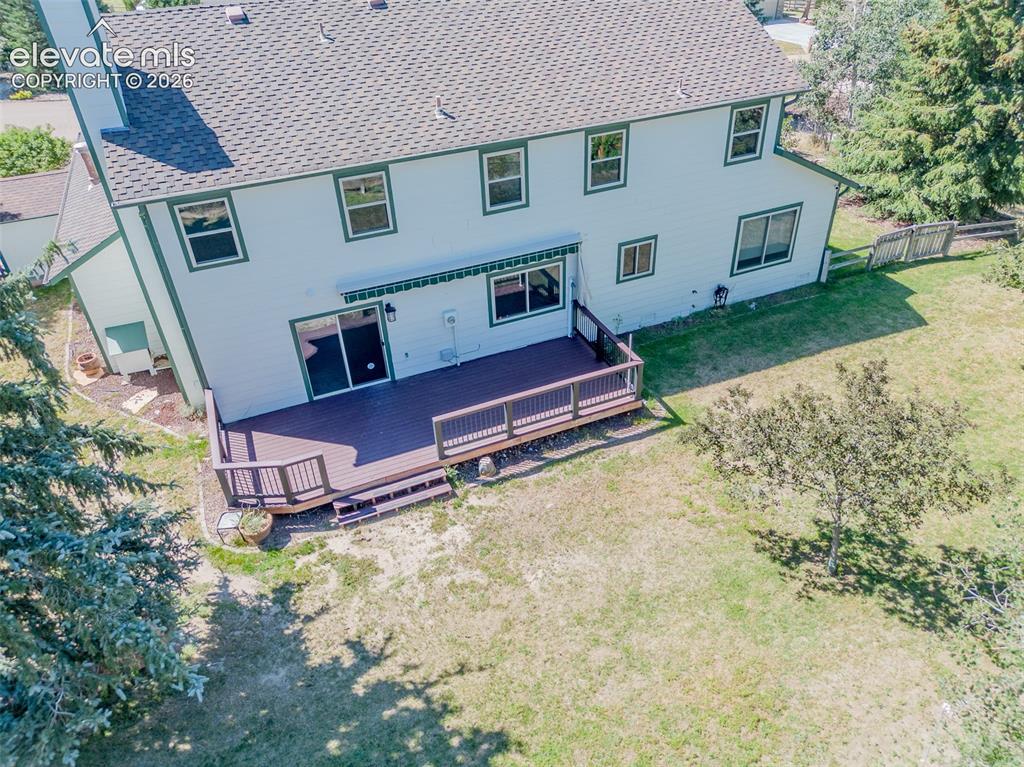 Image 8 of 47: Spacious rear decking with multi-level design and built-in railing