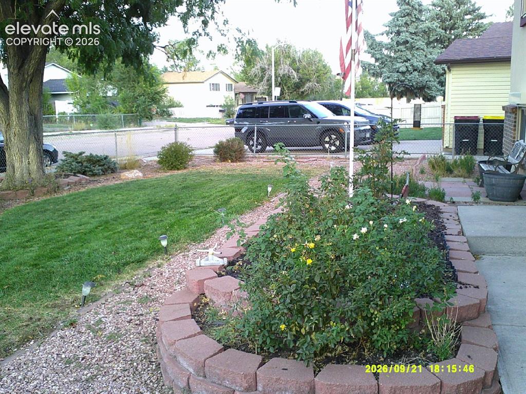 Image 5 of 26: Manicured lawn with a stone-edged garden bed and mature tree