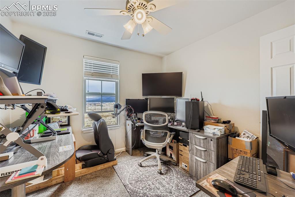 Image 10 of 27: Home office with light carpet and a ceiling fan