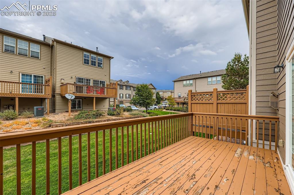 Image 15 of 27: Wooden terrace featuring a residential view and a lawn