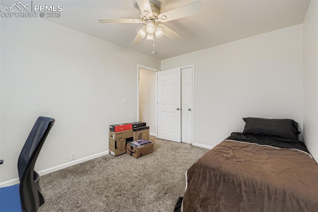 Image 22 of 27: Bedroom with carpet flooring and ceiling fan