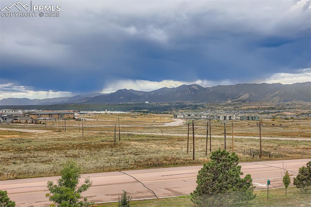Image 25 of 27: View of mountain backdrop with rural landscape