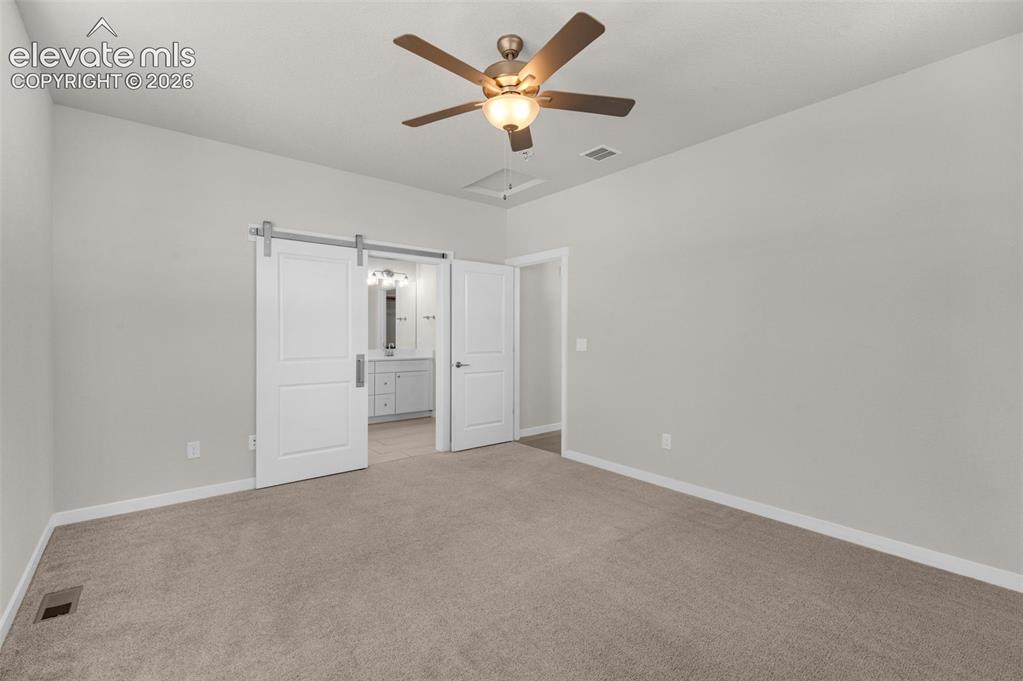 Image 16 of 34: Neutral-toned carpeted room featuring a ceiling fan with integrated lightin