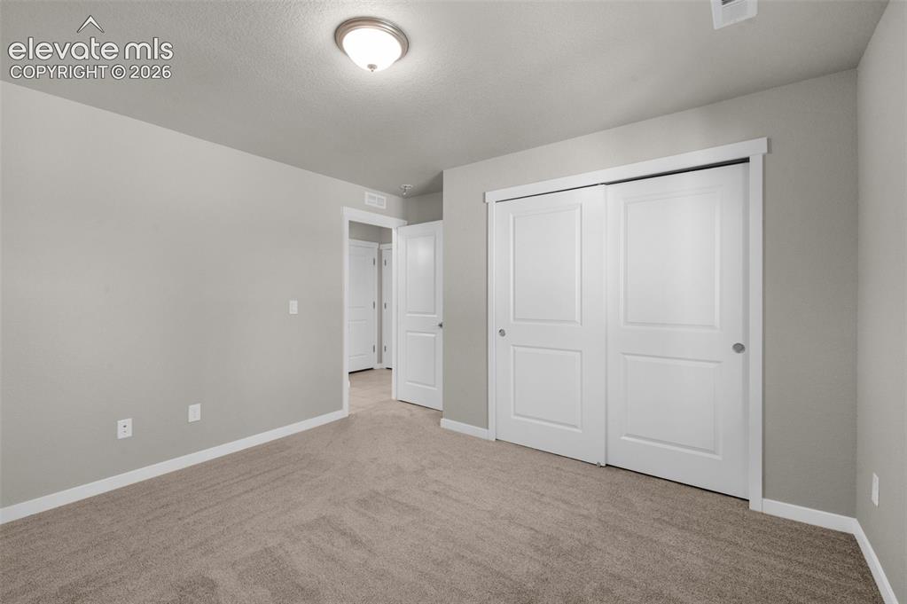 Image 22 of 34: Neutral interior featuring wall-to-wall carpeting, flush-mount ceiling ligh