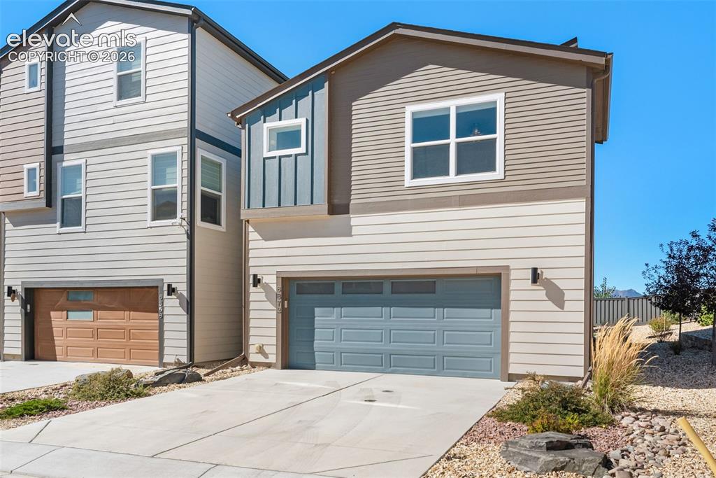 Image 25 of 34: Modern exterior featuring multi-toned horizontal lap siding, vertical board
