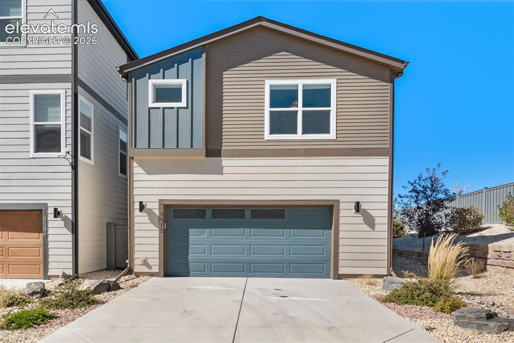 Image 26 of 34: Multi-level exterior featuring horizontal siding, vertical board-and-batten