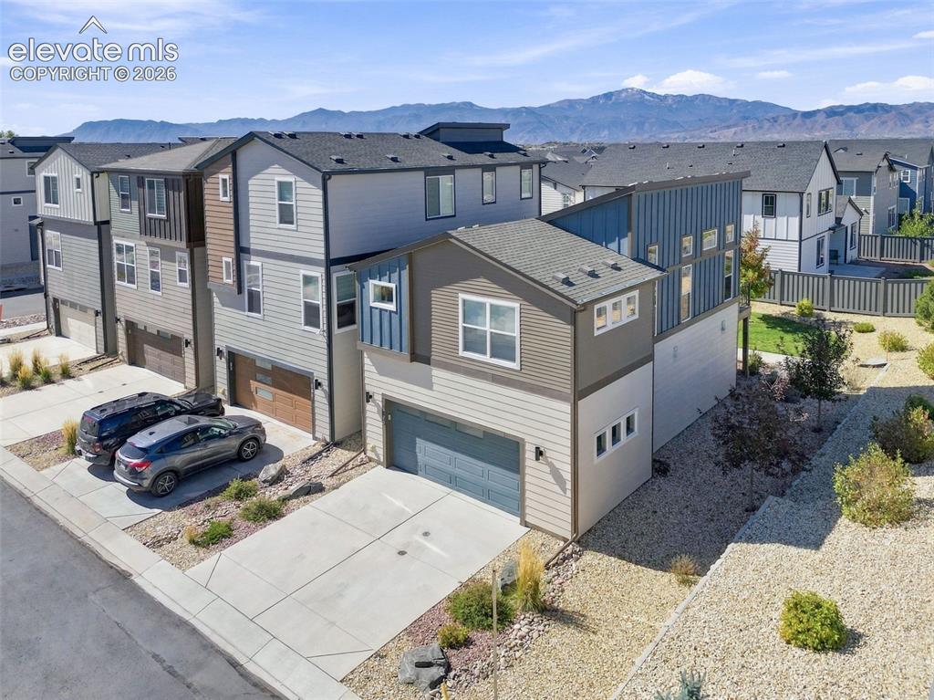 Image 31 of 34: Multi-story exterior featuring composite siding, attached two-car garages,