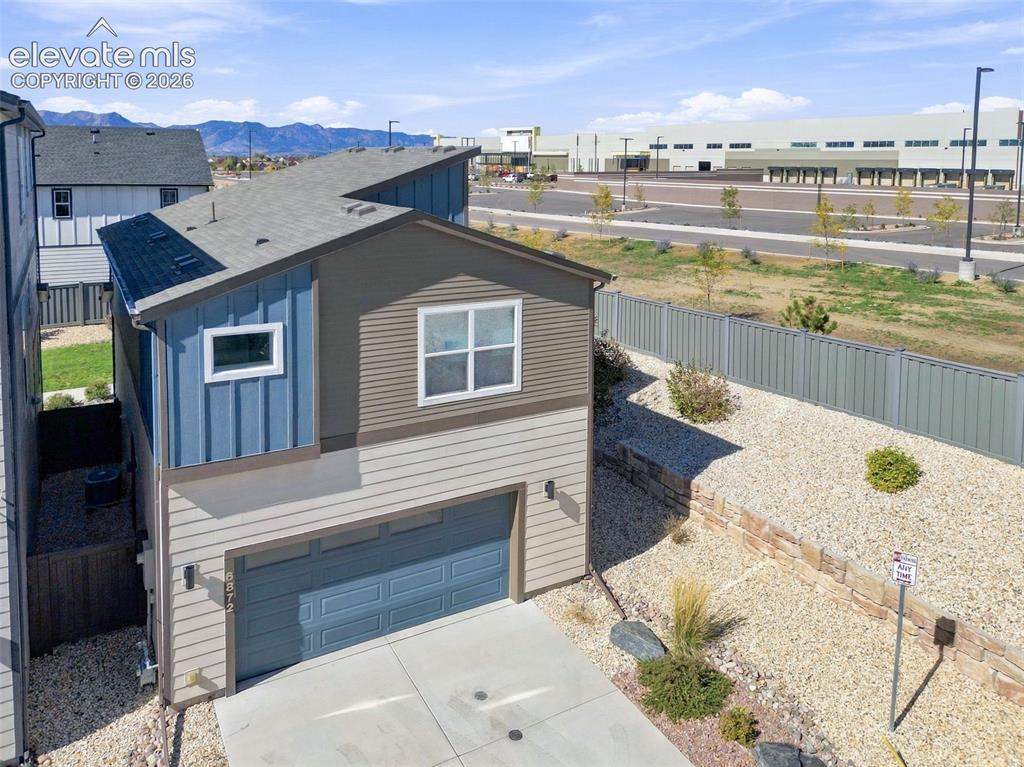 Image 33 of 34: Multi-level exterior featuring horizontal and vertical lap siding, a pitche