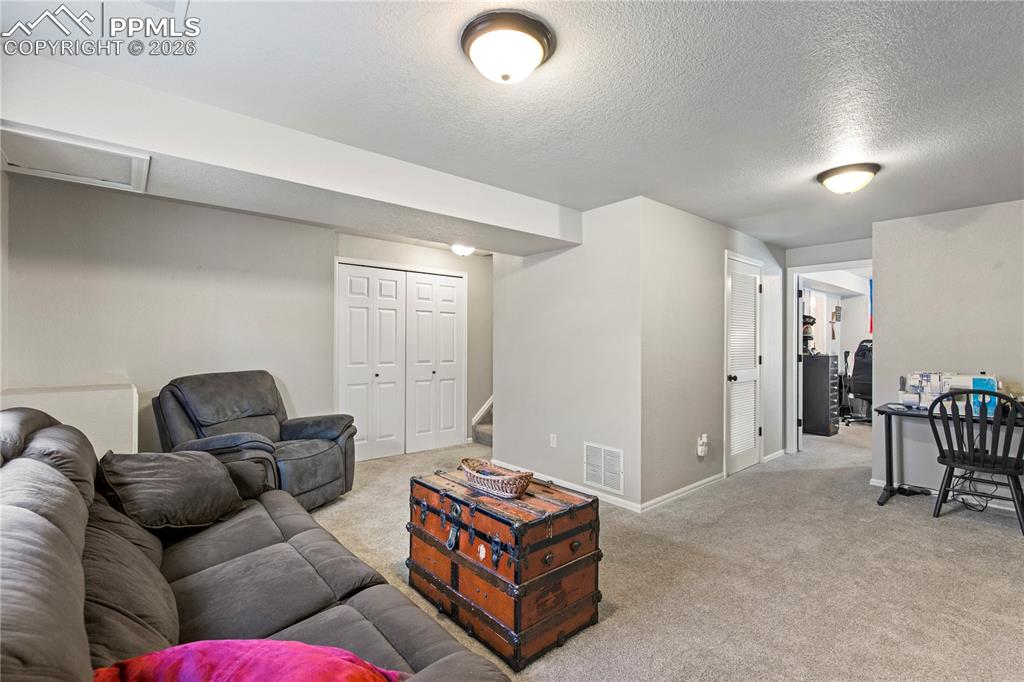 Image 19 of 27: Another view of family room in the basement