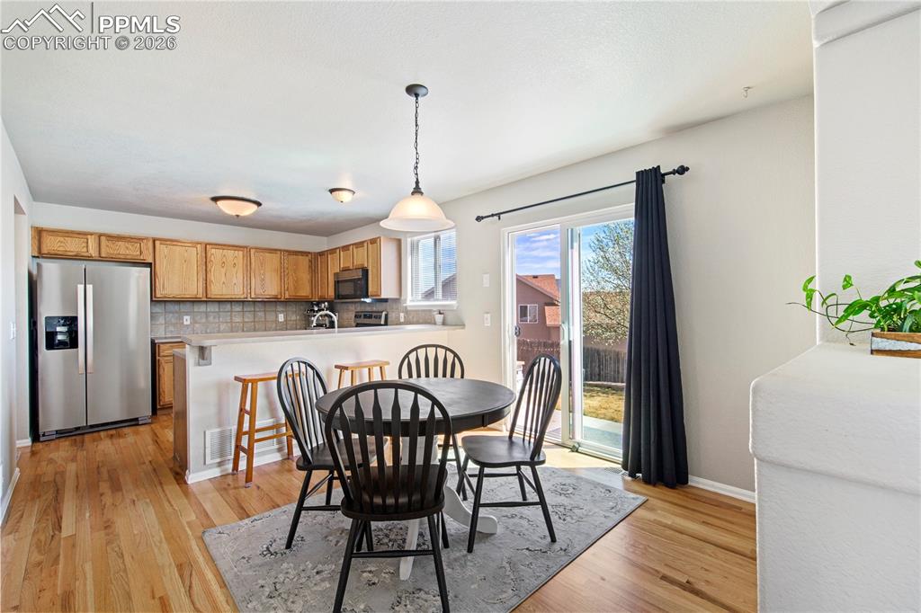Image 6 of 27: Harwood flooring in the eat in kitchen