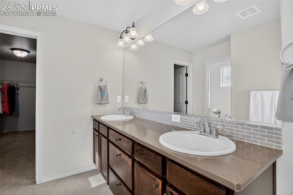 Image 17 of 46: Master bath dual vanities