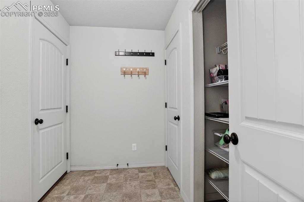 Image 24 of 46: Mudroom with closet and shelving