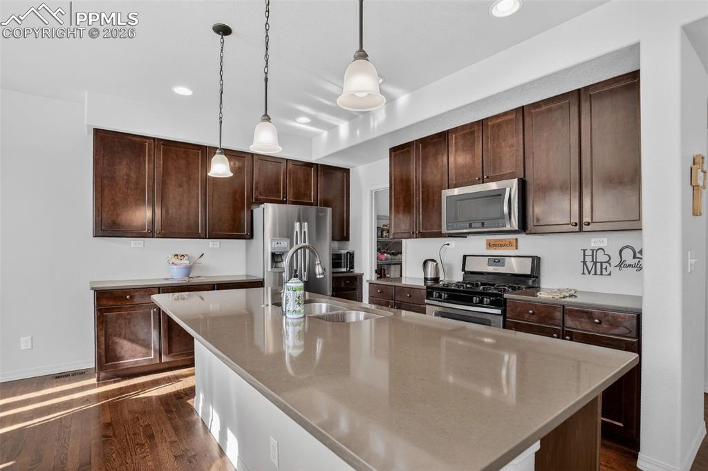 Image 6 of 46: Kitchen ss appliances and maple cabinetry