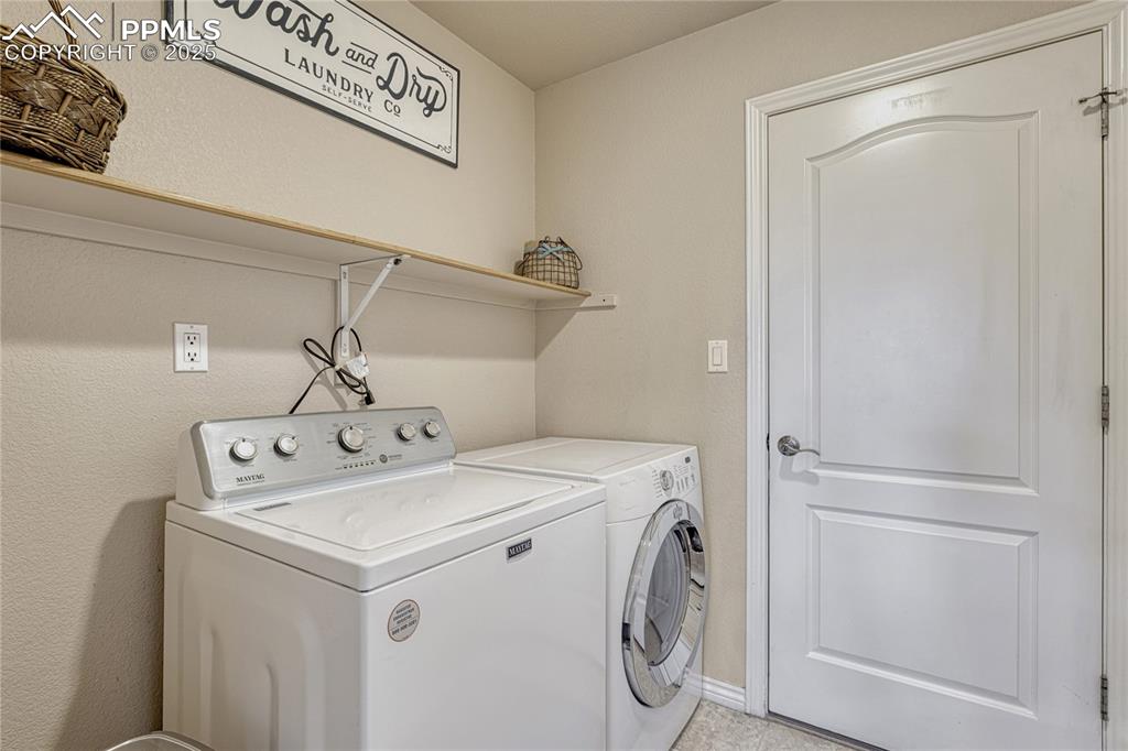 Image 22 of 48: Main level laundry with utility sink, storage and garage access. 