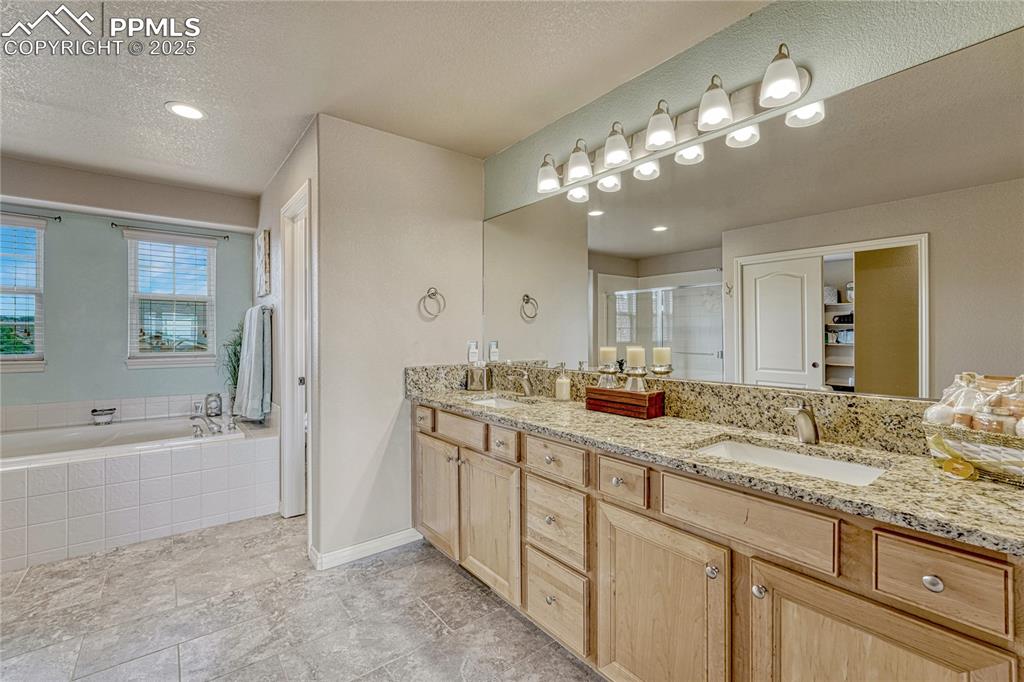 Image 26 of 48: Adjoining 5-piece bath with granite countertops...