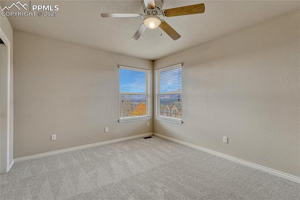 Image 30 of 48: First of two additional upstairs bedrooms with Pikes Peak and Front Range v