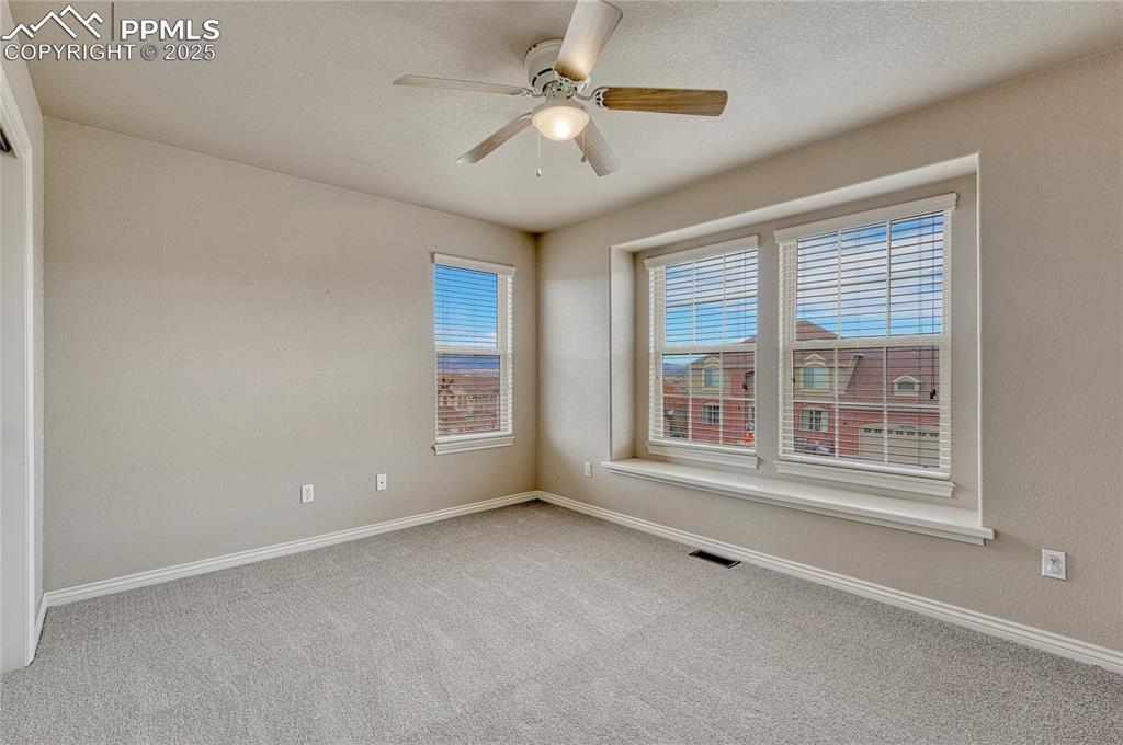 Image 32 of 48: Second of two additional upstairs bedrooms with amazing Front Range views. 