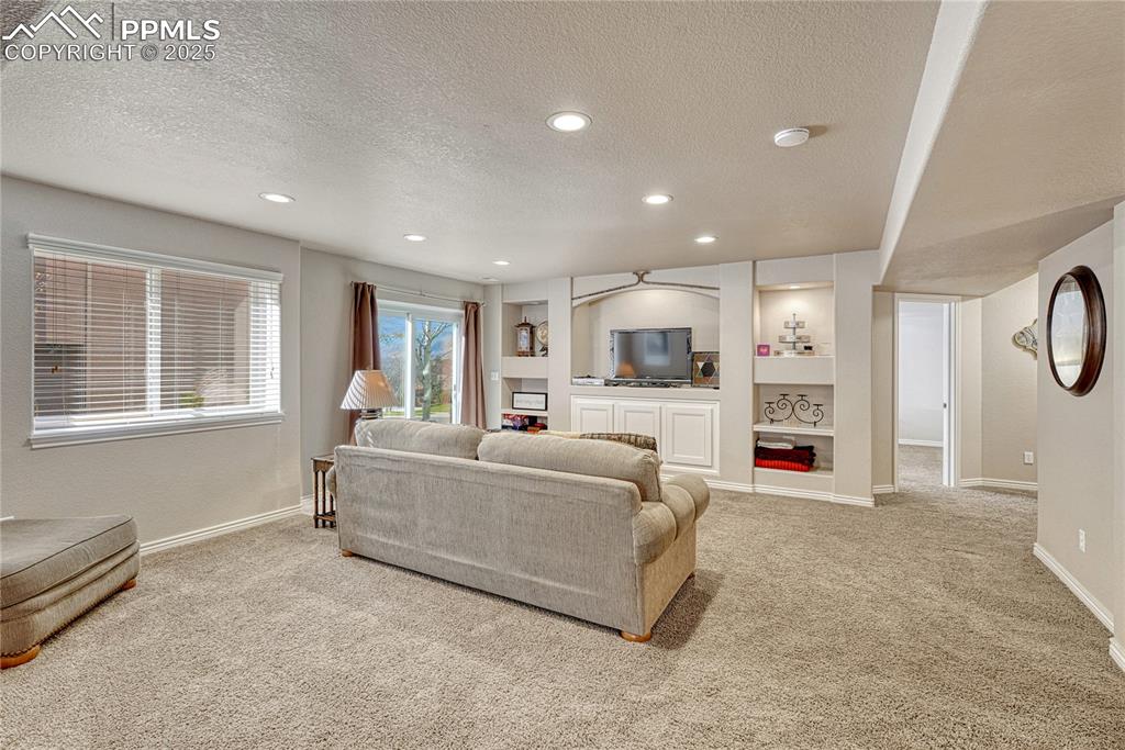 Image 38 of 48: Family room with entertainment and storage niches.