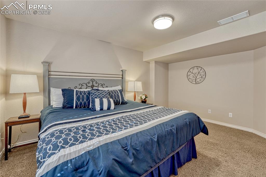 Image 41 of 48: First of two basement bedrooms...